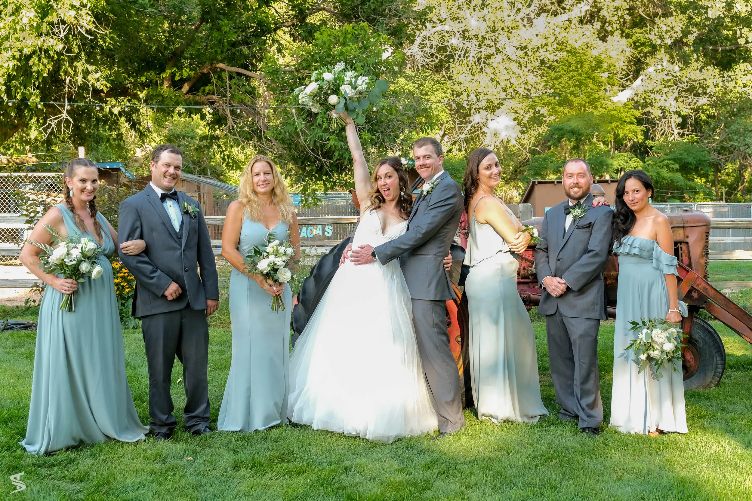 Wedding party gathered around a tractor