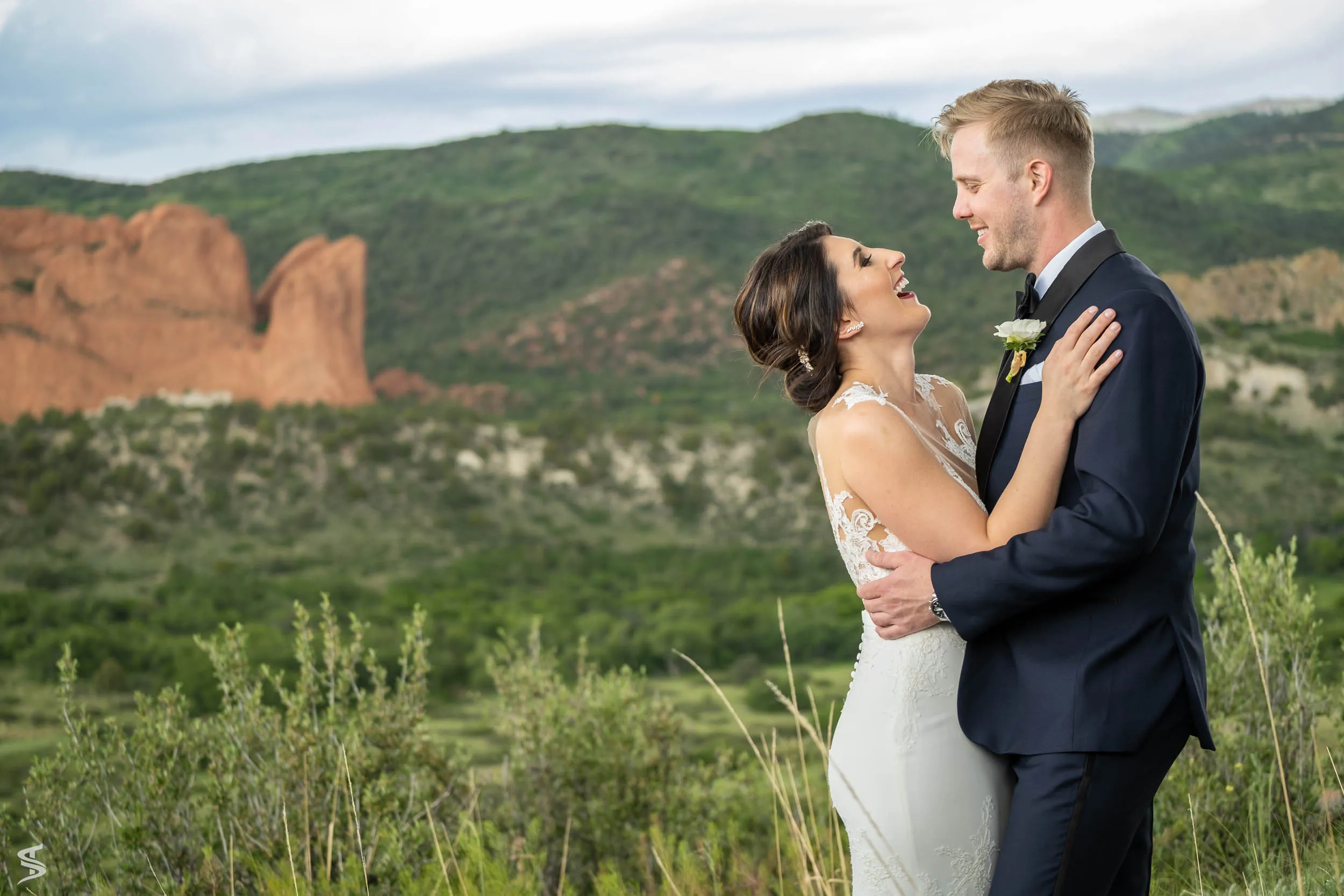 Bride laughing with the groom during their destination wedding portraits at Garden of the Gods, Colorado.