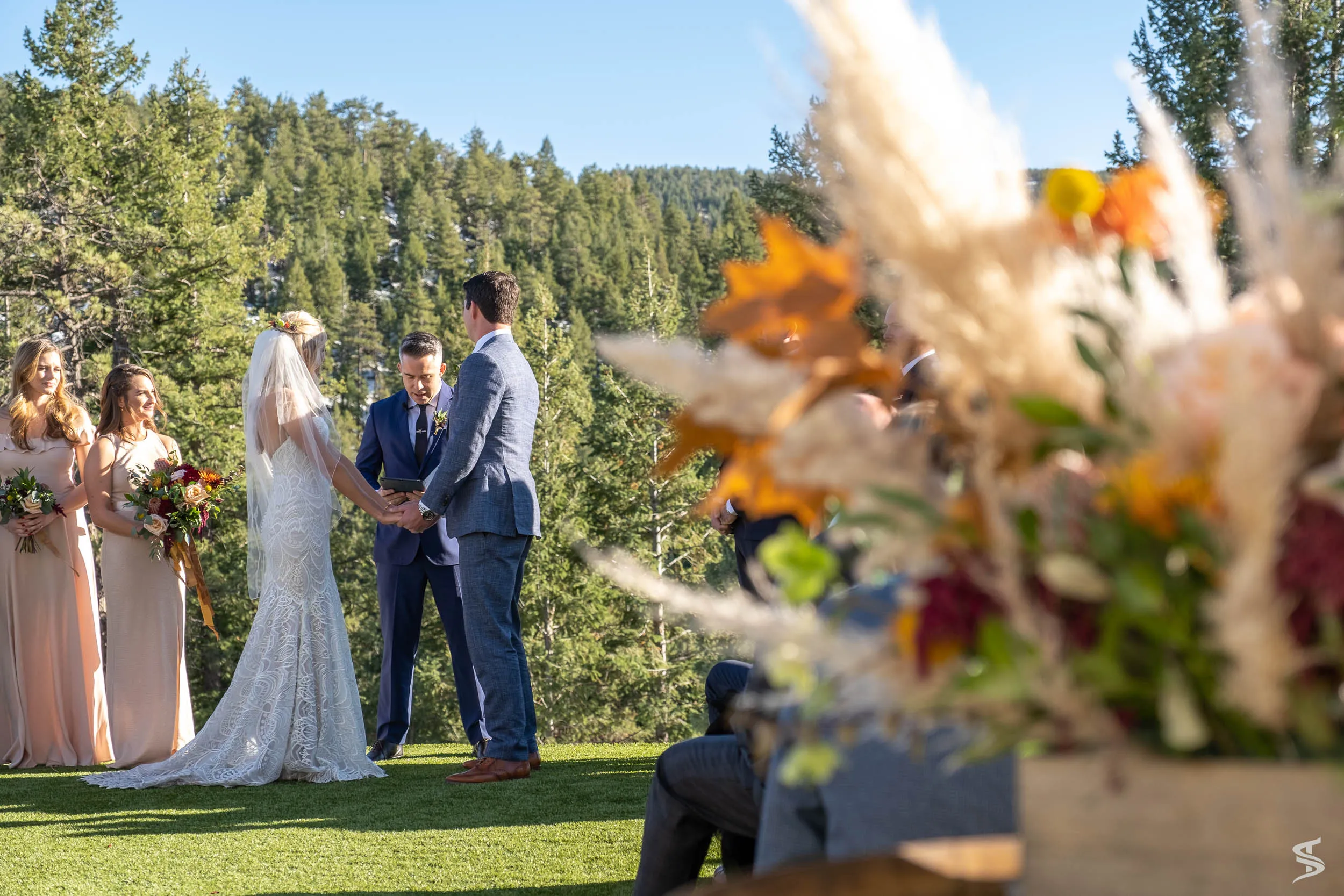 An outdoor wedding ceremony framed by flowers